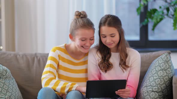 Happy Teenage Girls with Tablet Computer at Home