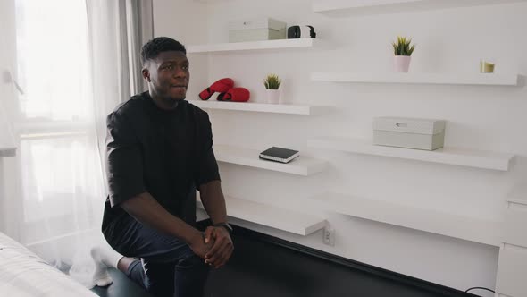 A Fit Man Dressed Black Shirt is Doing Forward Lunge Exercises at Home