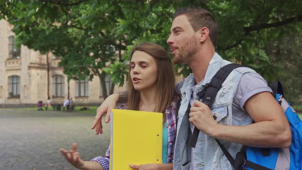 Male Student Embraces His Classmate on Campus