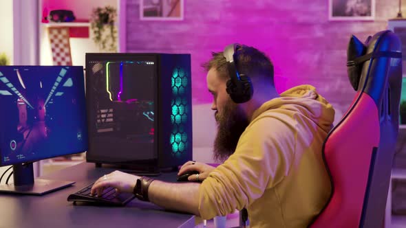 Focused Young Man Sitting on Gaming Chair