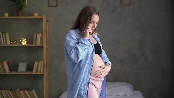 Beautiful Woman Holding Pregnant Belly and Using Phone Young Expecting Mom Talking on Mobile Phone