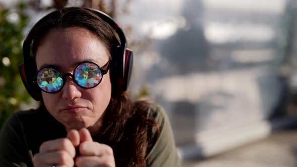 Closeup Portrait of a Happy Adult Woman Dancing on the Street with Glasses with Crystals Instead of