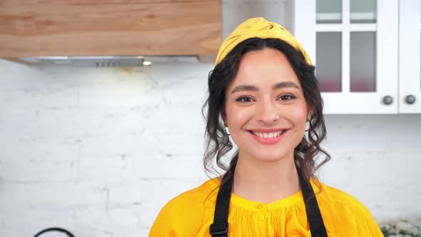 Close Up Smiling Housewife Turns Head Looking Camera in Home Modern Kitchen