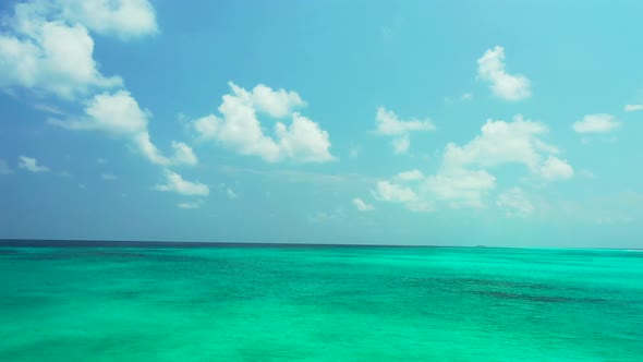 Tropical overhead travel shot of a white paradise beach and aqua turquoise water background in 4K