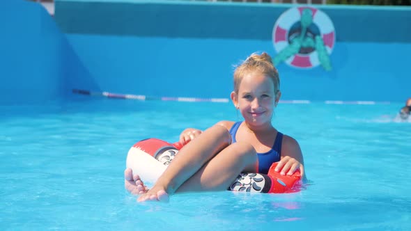 Happy Girl Playing in Outdoor Swimming Pool on Summer Vacation on Tropical Beach.