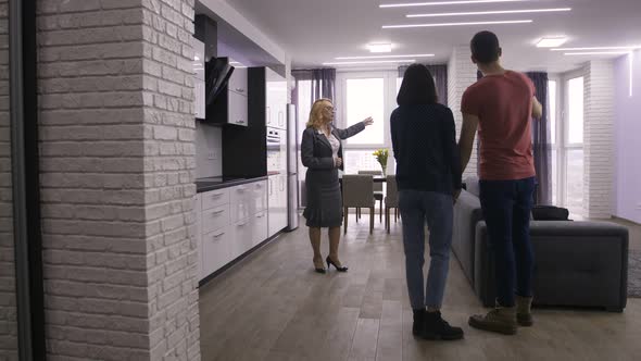 Couple Entering and Looking at New Apartment