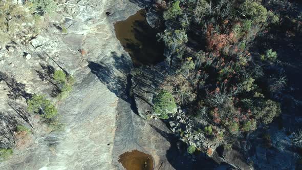 Aerial view of a dry creek bed in bush land