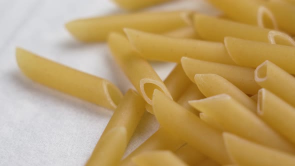 Italian penne pasta. Mediterranean cuisine ingredient on white