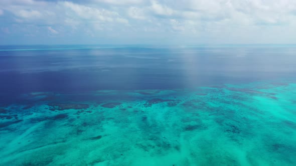 Tropical overhead island view of a white sand paradise beach and turquoise sea background in colourful