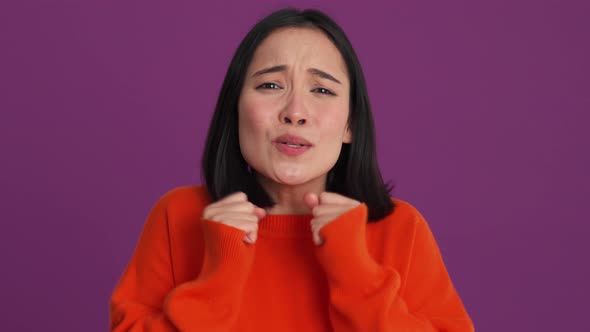 Happy woman in red sweater clapping hands