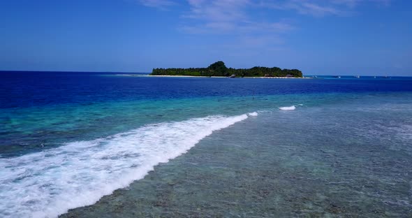 Wide angle overhead travel shot of a summer white paradise sand beach and blue sea background