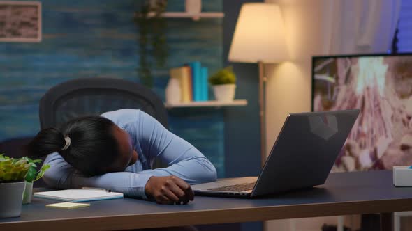 Exhausted Black Businesswoman Falling Asleep on Desk