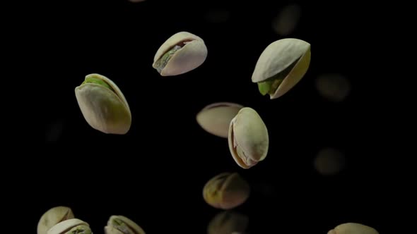 Closeup of the Delicious Salted Pistachios Bouncing on a Black Background