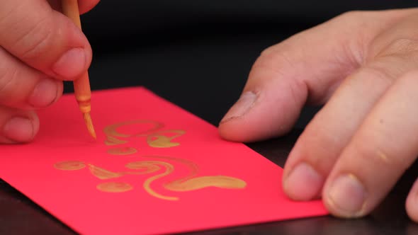 Vietnamese scholar writing calligraphy on the red envelope, ang pao in the lunar new year