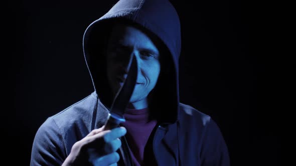 Angry Criminal with a Knife in His Hand