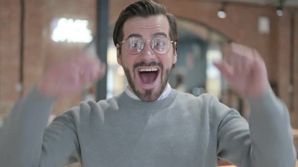 Portrait of Excited Young Man Celebrating Success