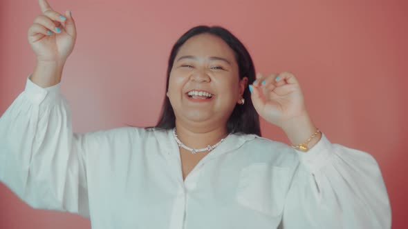 Asian Plus Size Woman in White Shirt Posing Isolated on Pink Background