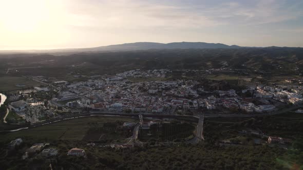 High rising aerial of the portuguese city Silves and the Arade river