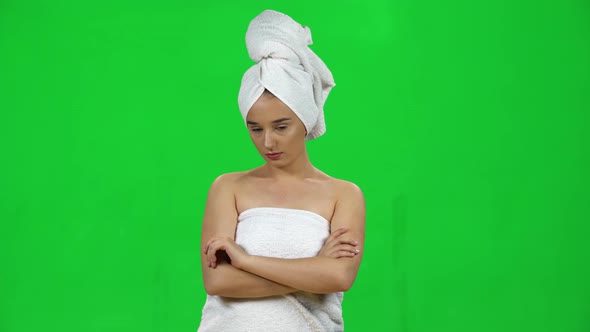 Girl in Towel on Her Head Is Very Offended and Looks Away on Green Screen at Studio