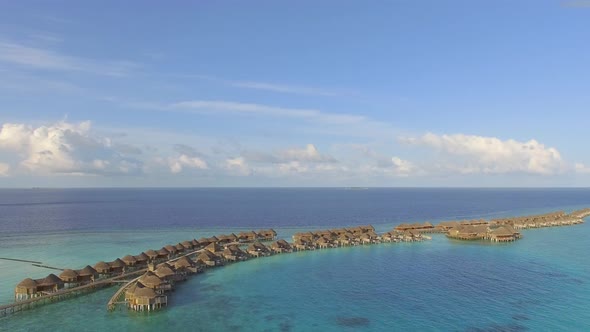 Aerial view above of amazing bungalow resort, Maldives island.