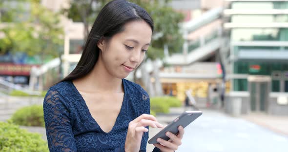 Woman use of mobile phone in city