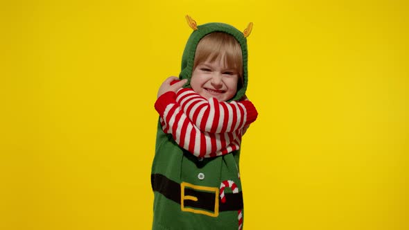 Kid Teen Girl Christmas Elf Santa Helper Costume Blows Air Kisses Camera Hugging Embracing