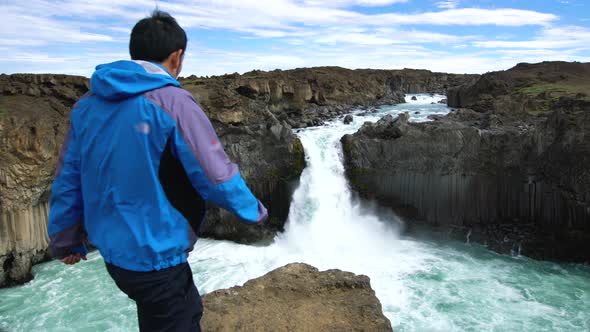 Traveler Hiking at Aldeyjarfoss Waterfall in Iceland