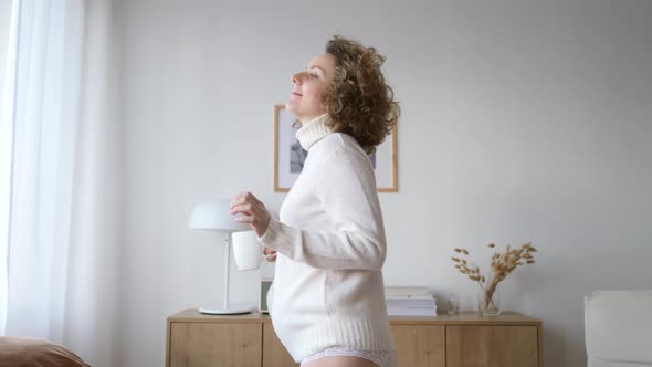 Happy Beautiful Pregnant Woman Dancing In The Morning With Cup Of Tea.