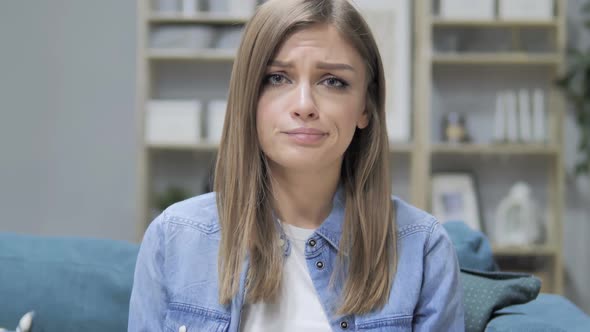 Portrait of Sad Young Girl Looking at Camera