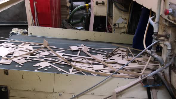 Machine carves cardboard boxes from sheets of cardboard. Manufacture of cardboard boxes. 