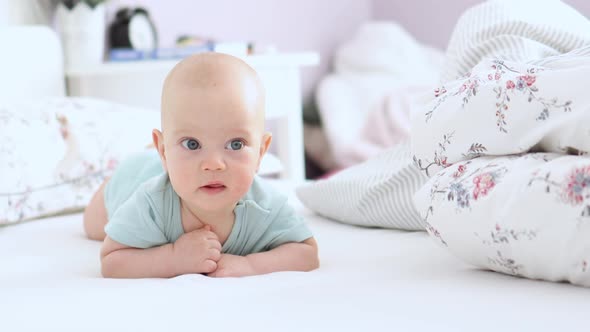 Beautiful Baby Lying in Bed Looking to Camera Happy Infant Bedroom Sunny Day