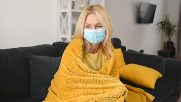 Senior Sick Woman Wearing Protective Face Mask Feeling Unwell at Home