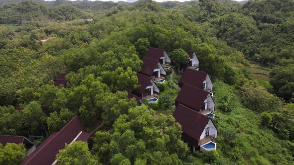 Aerial view of beautiful isolated villa with small swimming pool in the middle of a forest