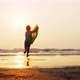 Little Girl Is Running on the Sea To Waves Holding Surfboard in Her Hands - VideoHive Item for Sale