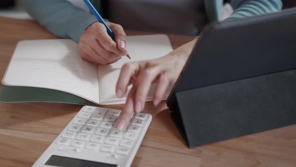 Close up of Businesswoman or female accountant freelancer hand using a calculator calculating