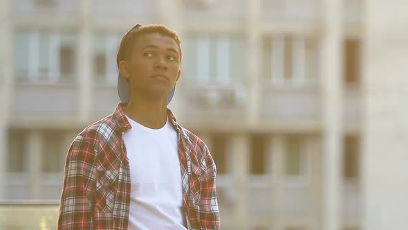 African-American Male Teenager Waiting Friends at City Street, Lifestyle