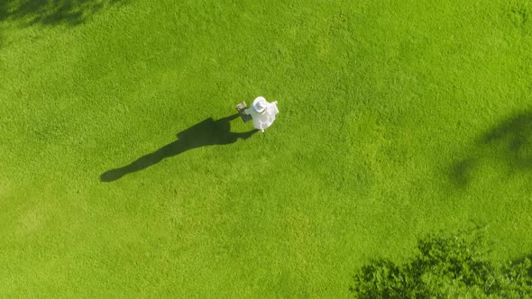 Tourist Walking By Green Park Natural Landscape  Aerial Footage Long Shadow