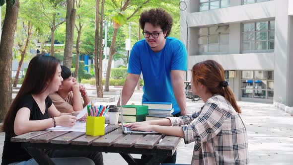 A happy group of attractive young people is tutoring exams alt