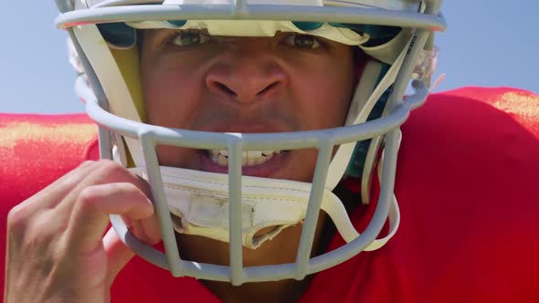 American football player standing with helmet