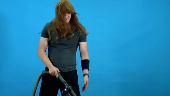 Guy with Long Hair Portrays a Rock Star