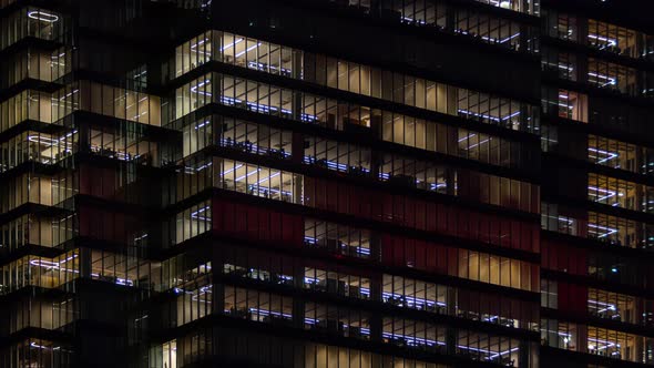 Time Lapse People Working Late Night Office Windows Light in Business Center Building Facade