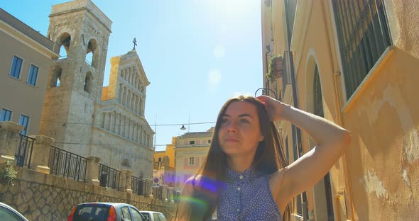 Young Tourist Female Walking Up the Small Street in Sunny Day. Girl Spending Vacation in Europe