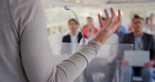 Female speaker adressing the audience at a business conference