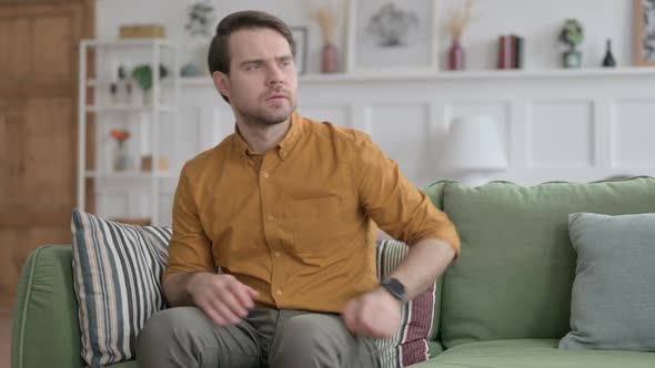 Young Man Standing Up Going Away, Leaving Sofa