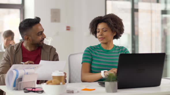 Creative Workers Discussing Papers at Office 13