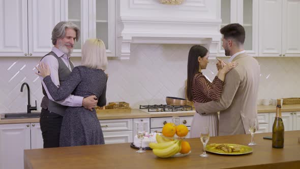 Family Dancing in Couples Together While Celebrating Birthday at Home