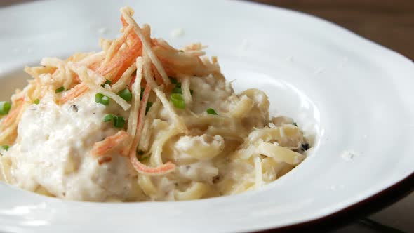 Plate of Cream and Herb Pasta on Table