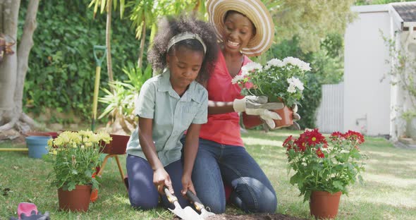 Mother and daughter gardening during a sunny day