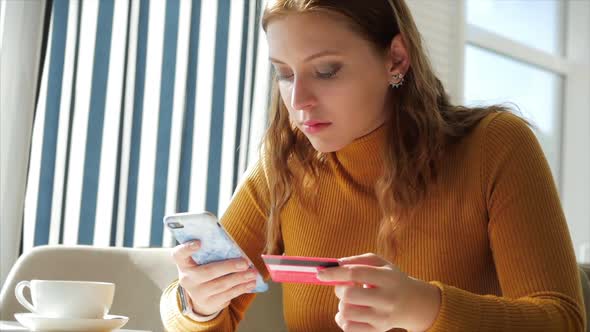 Beautiful Sunny Day Young Woman Drinks Morning Coffee in a Cafe, Making Online a Purchase Easy