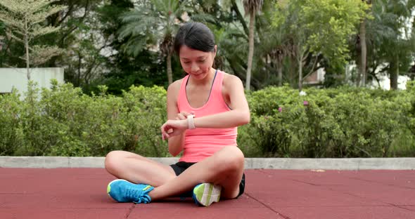 Woman use of smart watch at park